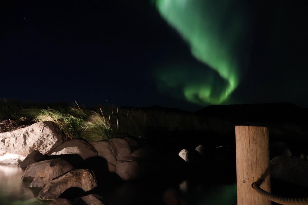 Polární záře v termálních lázních Hvammsvík